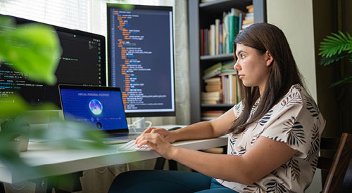 Person sitting at a desk programming