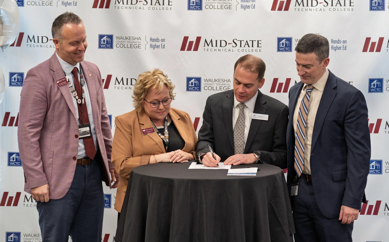 Leadership from Mid-State Technical College and Waukesha County Technical College sign the agreement to offer a new shared AI Data Specialist associate degree at a Feb. 6 signing event at the AMETA Center.