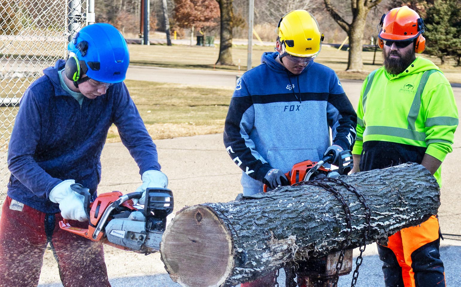 Tree Tech 2025 participants get chainsaw training by arboriculture professionals at the Wisconsin Rapids Campus.