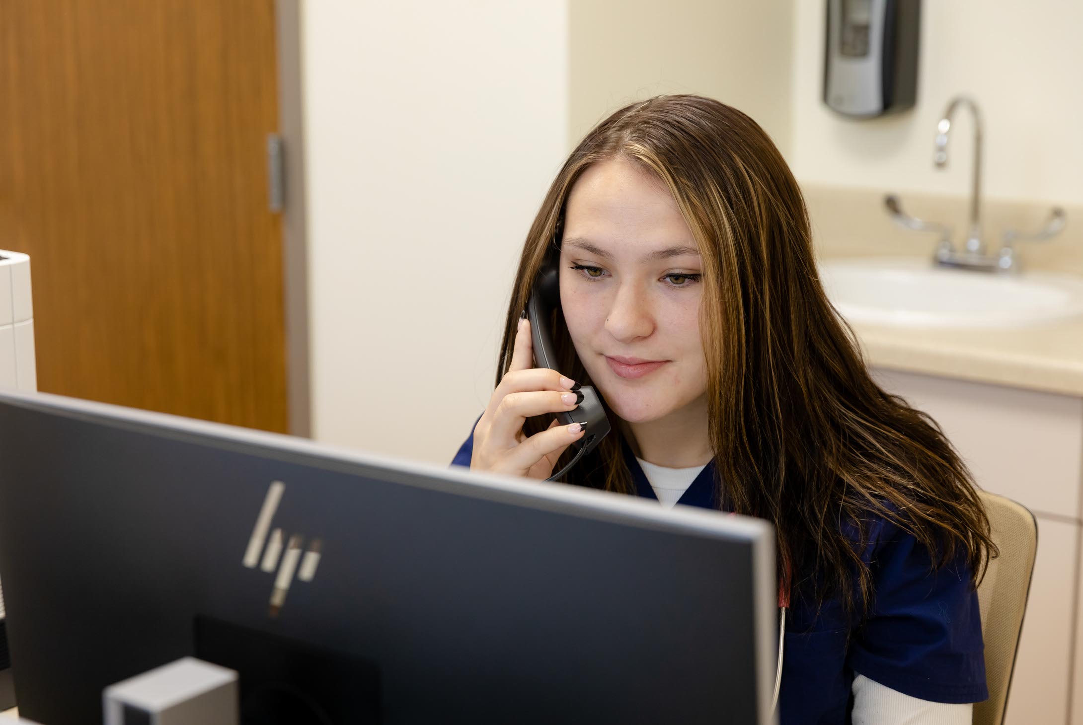 Healthcare Simulation Center student on phone.