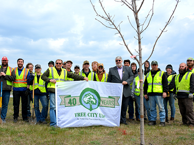 City of Stevens Point representatives, Skyward volunteers and Mid-State Technical College Arborist Technician students and instructor Joe Hoffman at the City’s April 27 Arbor Day tree planting event on EM Copps Drive. Stevens Point Superintendent of Forestry and Landscape Operations Todd Ernster, left, and Wiza hold up the banner celebrating the City’s 40th year as a Tree City USA.