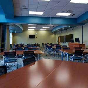 multiple rectangle tables with chairs set up around them multiple tvs mounted throughout the room