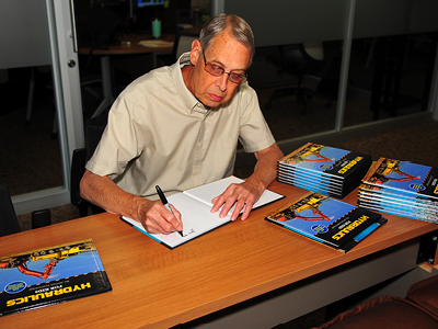 Jim Koehntopp signs copies of his new book on the Wisconsin Rapids Campus of Mid-State Technical College.