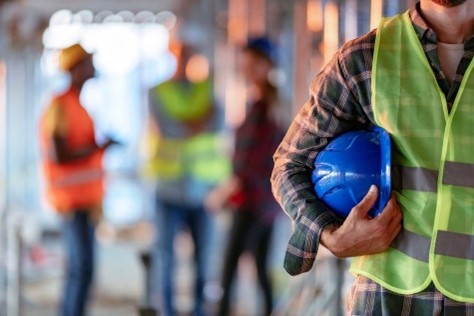 Construction Workers in bright vests wearing hard hats