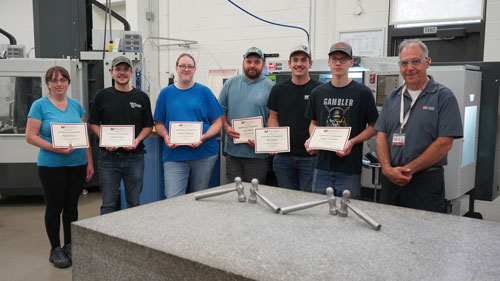 Metal Mania graduates receive their certificates of completion. From left: Metal Mania completers Molly Wenzel, Edward Colson, Angela Ashbeck, Sam Disher, Will Jensen and Logan Foemmel with Joe Byczynski, Precision Machining Technician instructor.