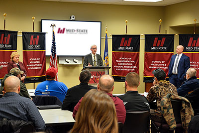Governor Tony Evers addresses an audience of apprentices and industry partners during his visit to the Wisconsin Rapids Campus of Mid-State Technical College, Tuesday, March 6. Also pictured, left to right, are College President Dr. Shelly Mondeik and Secretary Designee of the Department of Workforce Development Caleb Frostman.