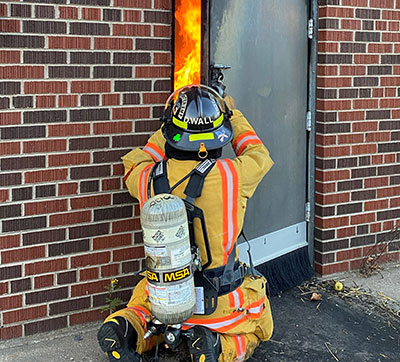 A Mid-State instructor monitors room temperature during a simulation for fire trainees and Fire Protection Technician students in the live burn room at the Marshfield Fire and Rescue Department Training Center.