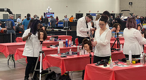 Sade Covington (left), bronze medalist in the Cosmetology event, competes against other SkillsUSA contestants in prepping hair styles on mannequins at the SkillsUSA State Leadership & Skills Conference in Madison, April 26.