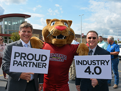 Wisconsin Manufacturers and Commerce President & CEO Kurt Bauer, Midstate Mascot Grit, and Marshfield Area Chamber of Commerce & Industry President, Scott Larson
