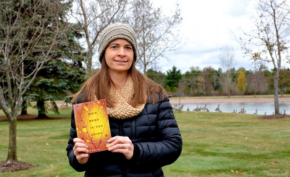 Mid-State Communication Instructor Jill Sisson Quinn with her published nonfiction essay collection “Sign Here If You Exist,” which recently won the Midwest Independent Publishers Association Book Award in the Autobiography/Memoir category.
