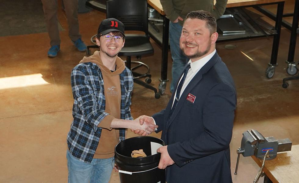 Construction Trades student Ryan Graczkowski receives an honorary toolbelt from Ryan Kawski, Mid-State dean of Advanced Manufacturing & Engineering and Transportation, Agriculture, Natural Resources, & Construction. Graczkowski is one of 10 students graduating from the program this spring who was celebrated at a hiring event on the Wisconsin Rapids Campus, April 28.