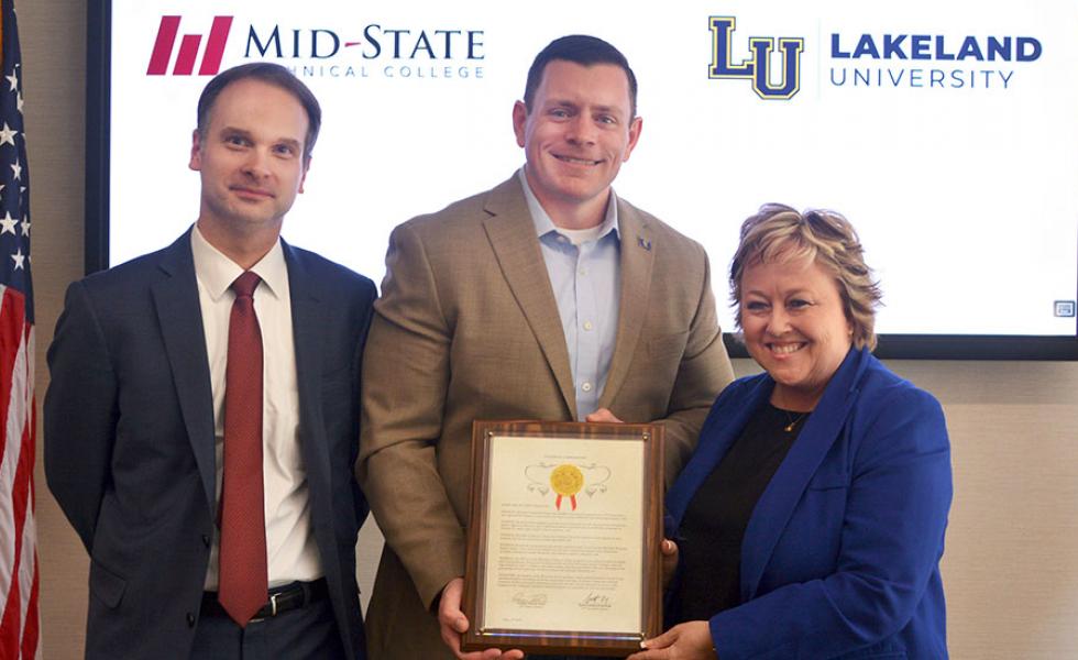 State Sen. Patrick Testin presents Lakeland University and Mid-State Technical College a citation commemorating the 30-year anniversary of the institutions’ partnership on May 17, 2022, on the Wisconsin Rapids Campus of Mid-State Technical College. From left, Dr. Joshua Kutney, Lakeland University vice president for academic affairs; Sen. Patrick Testin; and Dr. Shelly Mondeik, Mid-State president.