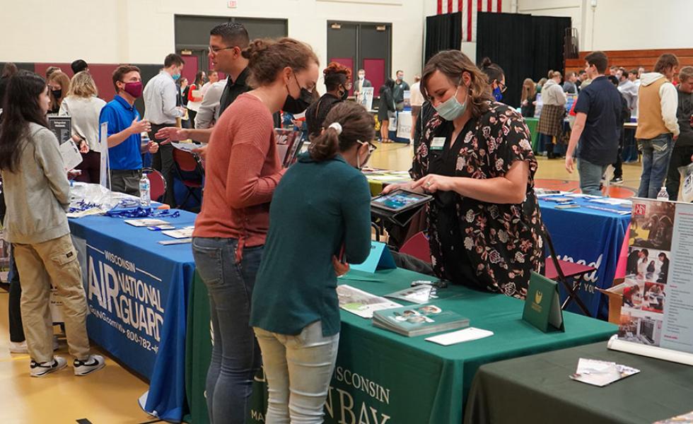 Attendees at the 2021 Wisconsin Education Fair chat with college representatives on the Wisconsin Rapids Campus of Mid-State Technical College. This year’s fair will be held Tuesday, Sept. 27.