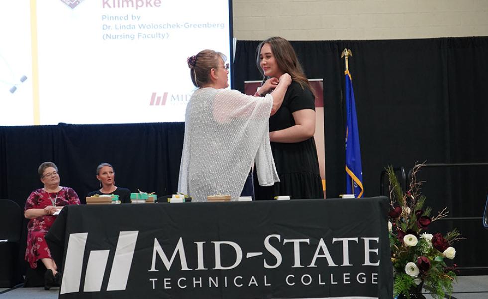 Mid-State Nursing program graduate Savannah Klimpke receives her nursing pin during the College’s pinning ceremony on the Wisconsin Rapids Campus, May 13.