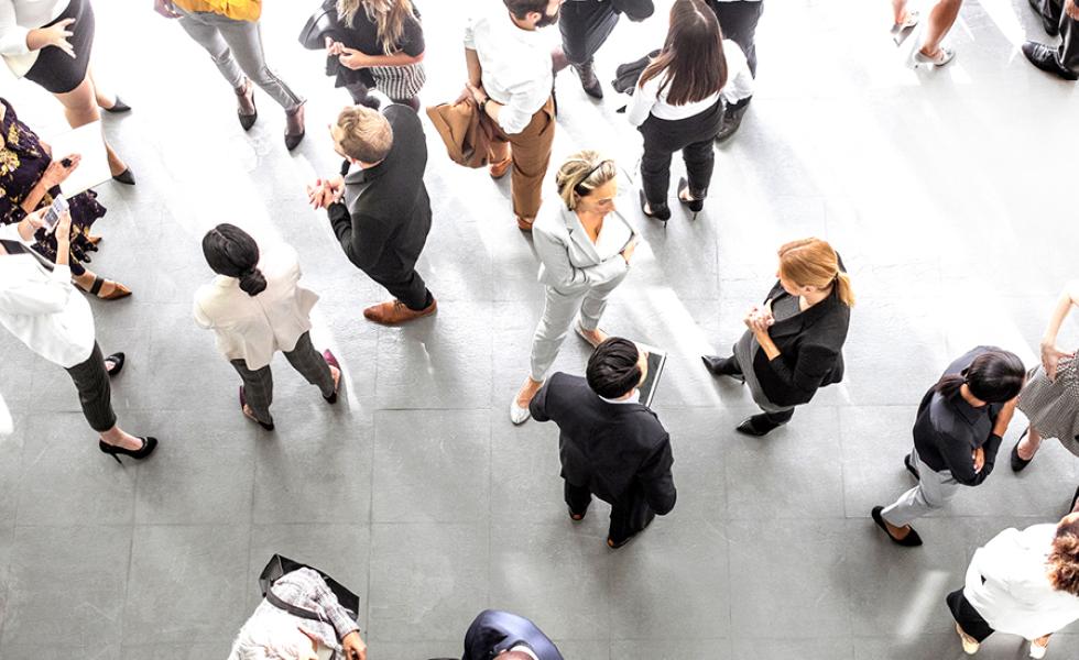 An overhead view of a group of people in business professional clothing.