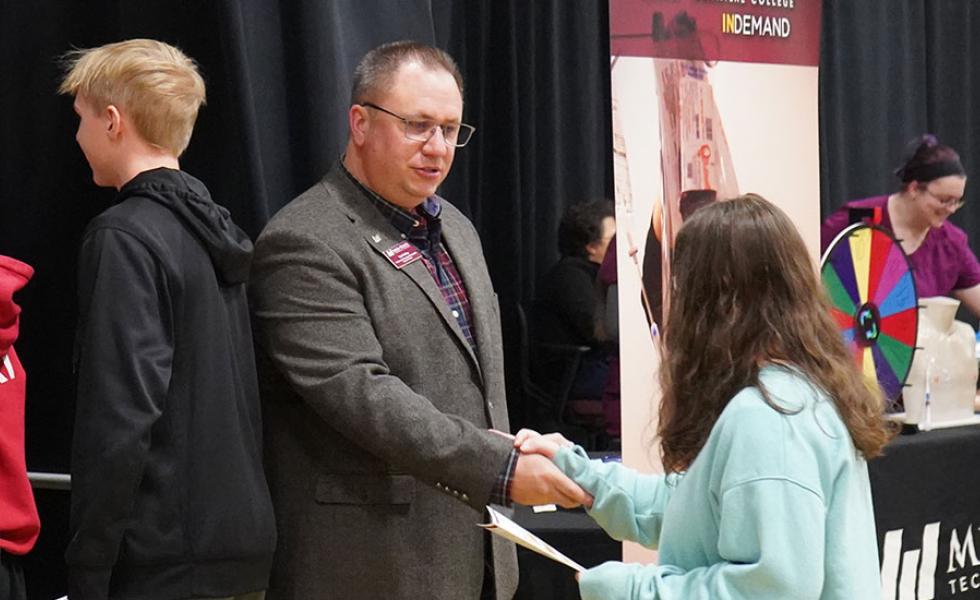 Ted Melby, Mid-State Technical College Workforce & Professional Development corporate trainer, shakes the hand of a local high school student at the March 2024 Program Showcase event. Melby will be a featured speaker at the Adams-Friendship High School Workforce Professionalism Day to be held on Thursday, April 25.