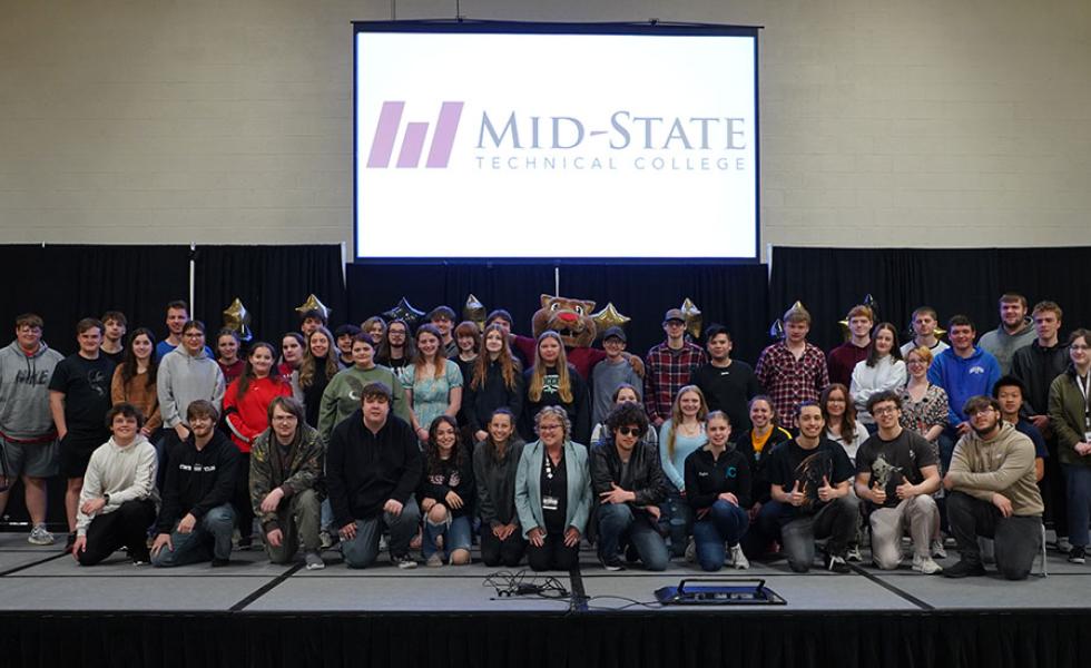 Admit Day attendees who committed to attending Mid-State upon graduating from high school at the May 2024 event. Also pictured: Mid-State’s mascot, Grit, and Mid-State’s president, Dr. Shelly Mondeik, center. This year’s event is being held on Friday, May 2.