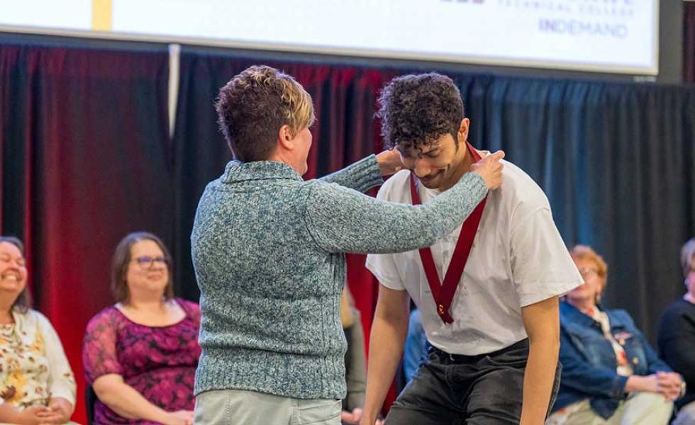 Mid-State Technical College Nursing program graduate Shawn Rones receives his nursing pin from Mid-State Nursing Instructor Tracy Joosten during the College’s pinning ceremony on the Wisconsin Rapids Campus, May 20.