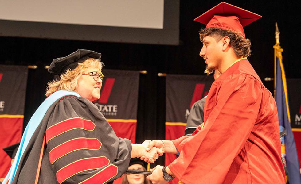 Mid-State President Dr. Shelly Mondeik congratulates a graduate during the presentation of diplomas at the College’s fall commencement on the Wisconsin Rapids in December. Spring commencement will be held on Saturday, May 17, on the Wisconsin Rapids Campus.