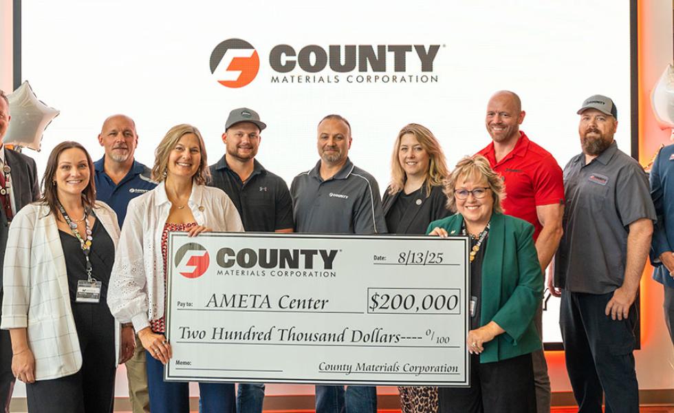 From left, Rebecca Sonnentag, executive vice president of marketing and communications at County Materials Corporation, and Dr. Shelly Mondeik, president of Mid-State Technical College, hold up the $200,000 donation from County Materials Corporation in support of the AMETATM Center, surrounded by staff from both organizations. The check presentation took place at the AMETA Center, in Stevens Point, Wednesday, Aug. 13, 2025.