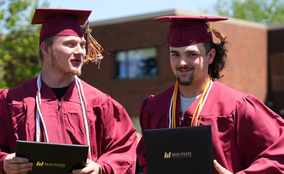 Two Mid-State Technical College graduates just after receiving their diplomas at the spring commencement on the Wisconsin Rapids Campus, May 16, 2026.