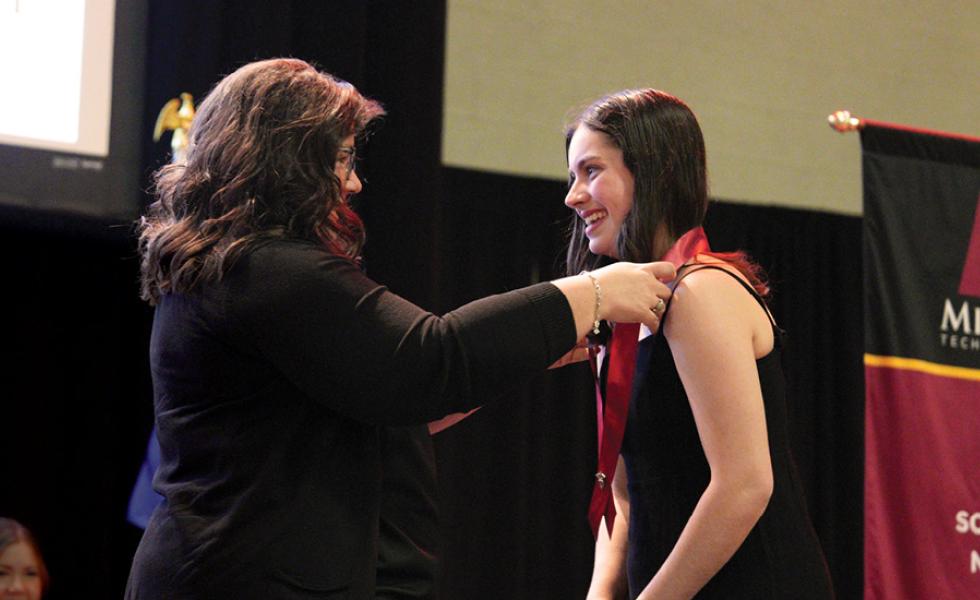 Mid-State Technical College Nursing program graduate Katie Hames receives her nursing pin from Mid-State Nursing Instructor Kristi Busscher during the College’s pinning ceremony on the Wisconsin Rapids Campus, May 19.