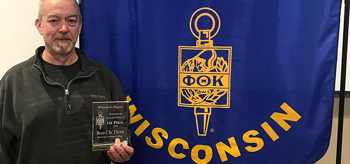 Dwayne Corry, Mid-State Technical College Digital Marketing student and active member of the College’s PTK chapter, proudly displays the Phi Theta Kappa Honor Society (PTK) Honors in Action project first-place award at the PTK regional conference in Wausau.