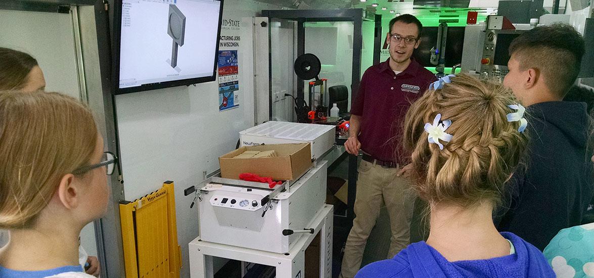 A group of College Camp guests learn about advanced manufacturing processes in the MIKE, Mid-State’s mobile manufacturing lab. The MIKE lets participants use a computer to design a product, create code to operate an automated machine, vacuum form their own design into a mold and reverse engineer a product using a 3D laser scanner. The workshop is just one of the options available in this summer’s College Camp on June 12.
