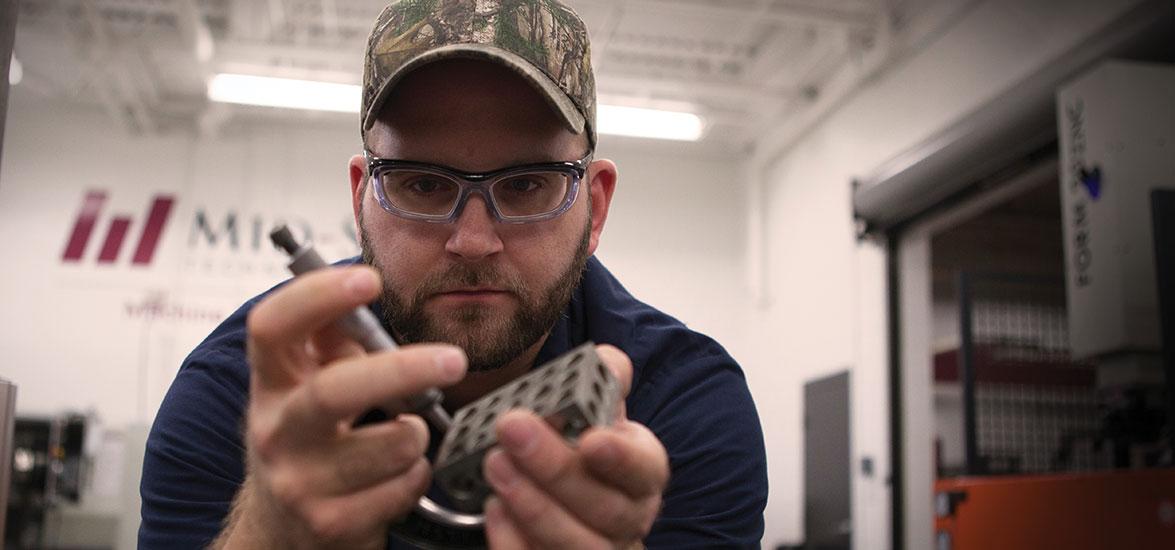 Machine Tool Technician student works with tools in Mid-State's machine tool lab