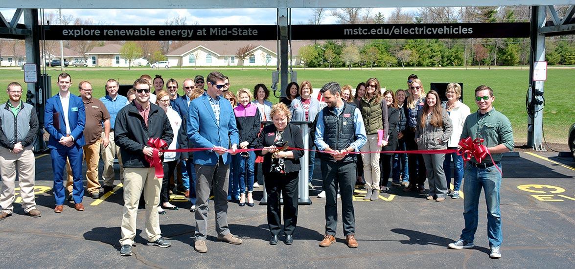 Mid-State President Dr. Shelly Mondeik cutting the ribbon on Mid-State’s new solar-powered car charging station on the Wisconsin Rapids Campus, Friday, May 10. Also pictured, from left: 2018 Renewable Energy Technician graduate and North Wind Renewable Energy Cooperative Warehouse Manager Mason Chuco, Wisconsin Rapids Mayor Zach Vruwink, Mid-State Renewable Energy Instructor Ben Nusz and Mid-State Renewable Energy Technician student Kenneth Schuelke.