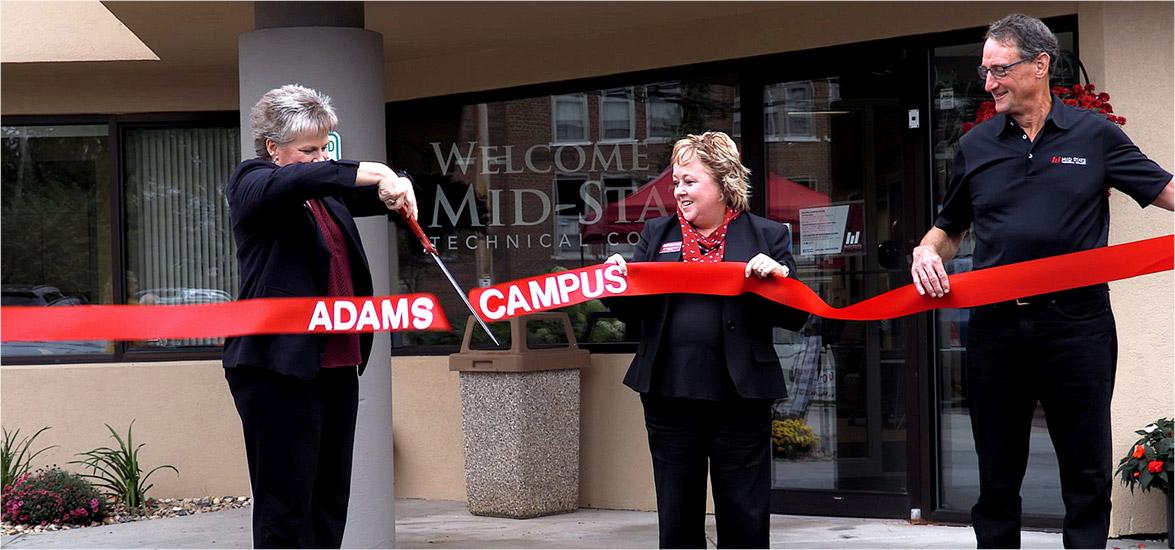 Campus Dean Laurie Inda cuts the ribbon on Mid-State Technical College’s Adams Campus at the Oct. 1 ribbon cutting and open house event. Assisting her are Mid-State President Dr. Shelly Mondeik, center, and Mid-State Board Member and Treasurer Charles Spargo.