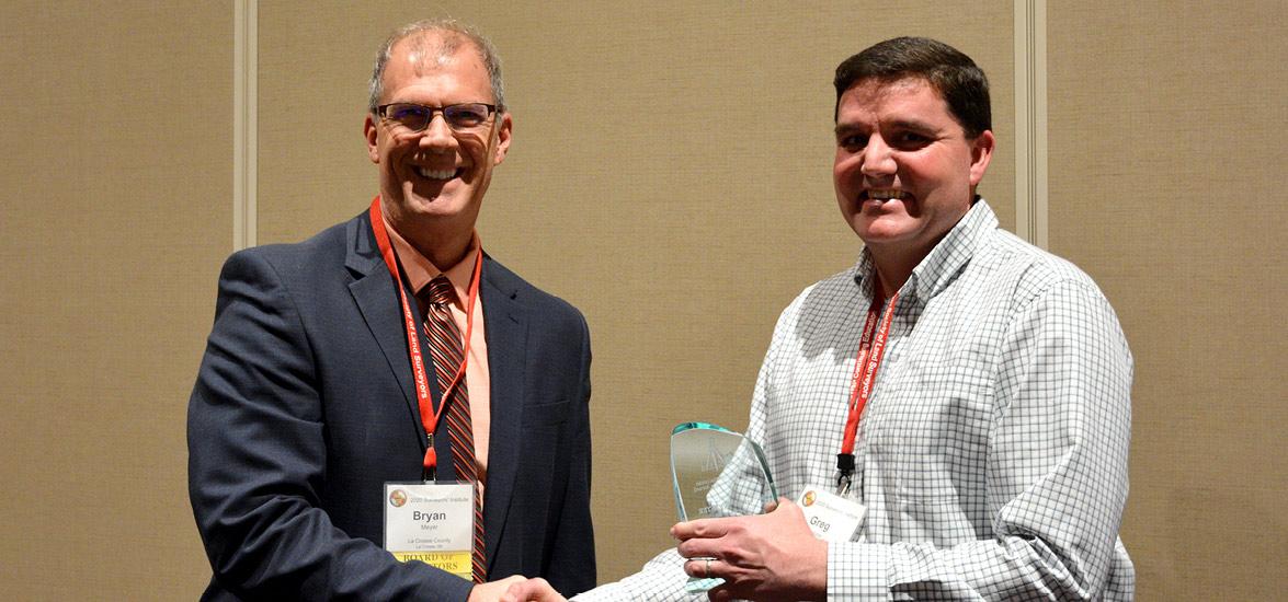 Mid-State Technical College Civil Engineering Technology-Highway Technician Instructor Greg Webster, right, receiving the Friend of Wisconsin Land Surveying Award at the organization’s annual Surveyors’ Institute Jan. 30 in Wisconsin Dells. Presenting him with the award is Bryan Meyer, LaCrosse County surveyor and president of the Wisconsin County Surveyors Association.