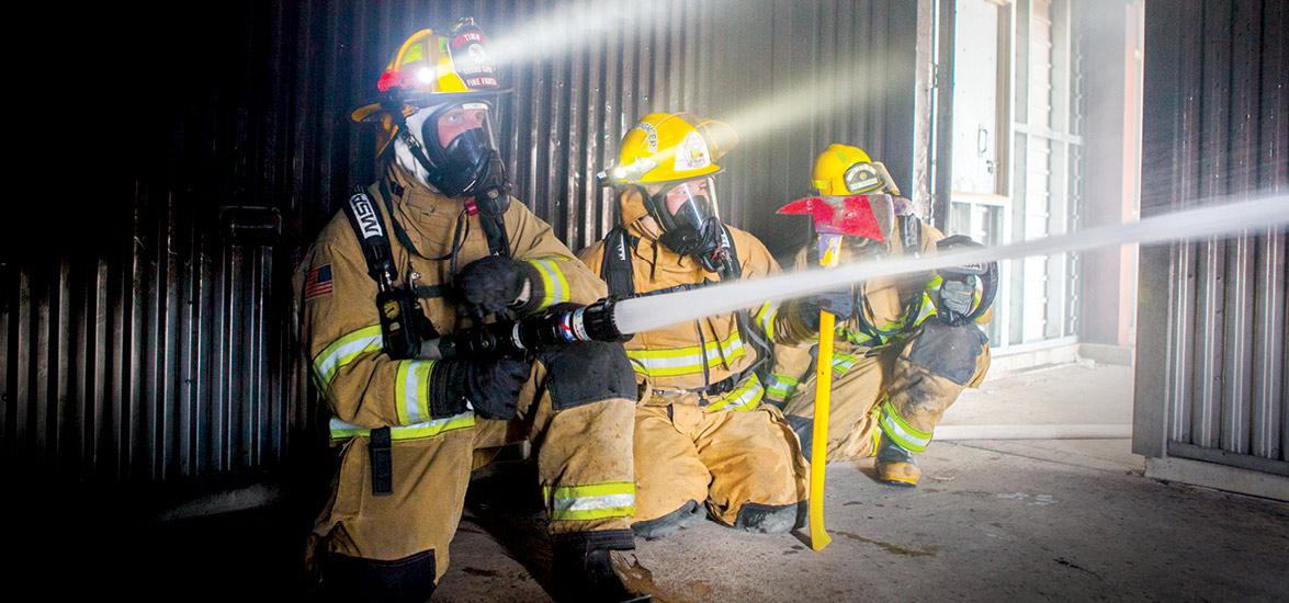 Mid-State Technical College students during a fire suppression exercise in the Fire Protection Technician associate degree program. The scene offers a preview of the hands-on preparation planned for students enrolling in the new Firefighter Technician Academy.