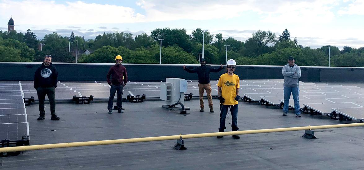 Renewable Energy Technician students strike a socially distanced pose with their recently installed solar panels on the roof of the Stevens Point Campus of Mid-State Technical College this June. The project provided valuable hands-on experience as part of an summer advanced solar installation course.