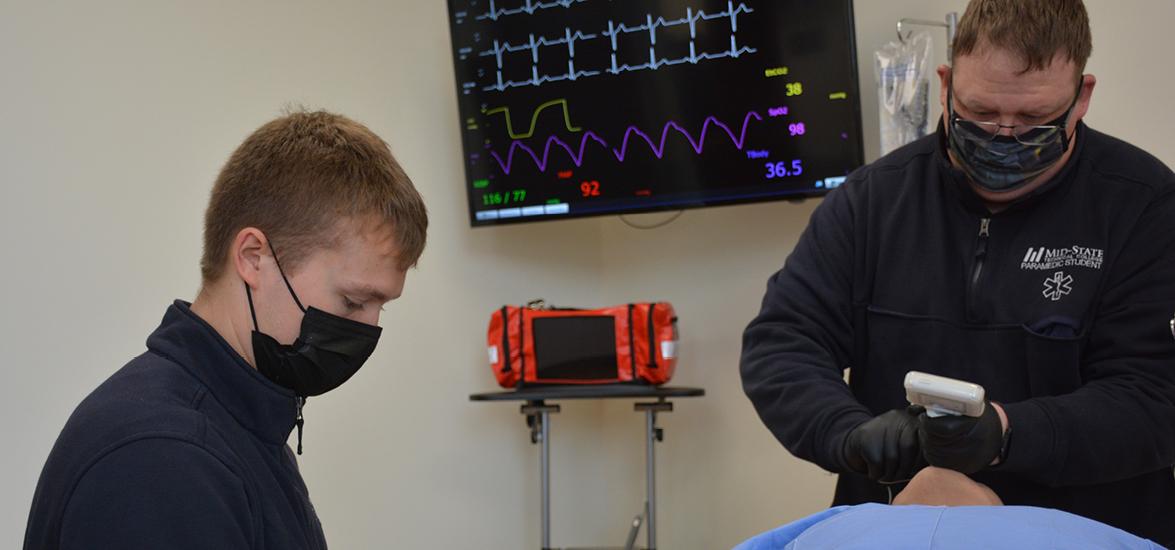 Mid-State Technical College EMT-Paramedic students practice their skills on a high-fidelity manikin in the Health Care Simulation Center in Wisconsin Rapids. Austin Brace, left, starts an IV, while Michael Forlines intubates the patient to secure an airway. 