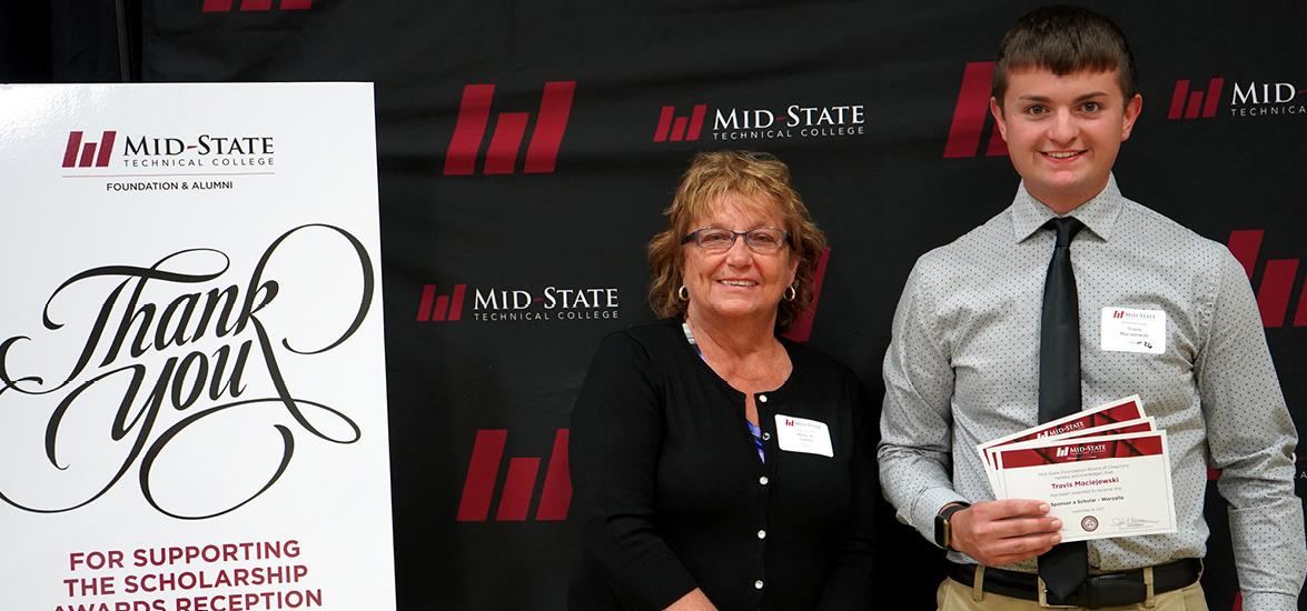 Mid-State Industrial Automation & Controls Engineering Technology student Travis Maciejewski with Mid-State Foundation Board President Mary Jo Green at the annual Foundation Scholarship Reception on the Wisconsin Rapids Campus on Sept. 16. Maciejewski was awarded three scholarships totaling $11,000, including his two-year Sponsor a Scholar award. 
