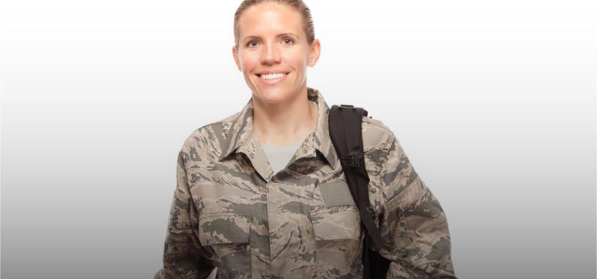 Woman in uniform with a backpack slung over her shoulder.