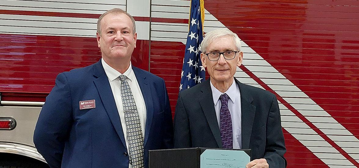 Mid-State Technical College Associate Dean of Protective & Human Services Rick Anderson, left, with Gov. Tony Evers just after the signing of Assembly Bill 297 on Dec. 6 at the Amherst Fire District. station. 