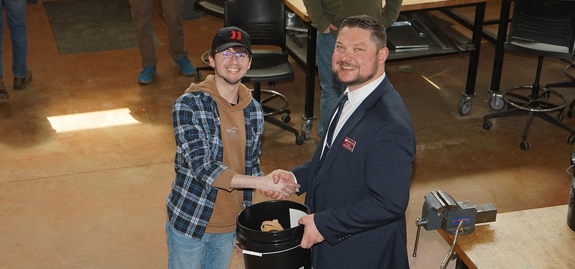 Construction Trades student Ryan Graczkowski receives an honorary toolbelt from Ryan Kawski, Mid-State dean of Advanced Manufacturing & Engineering and Transportation, Agriculture, Natural Resources, & Construction. Graczkowski is one of 10 students graduating from the program this spring who was celebrated at a hiring event on the Wisconsin Rapids Campus, April 28.