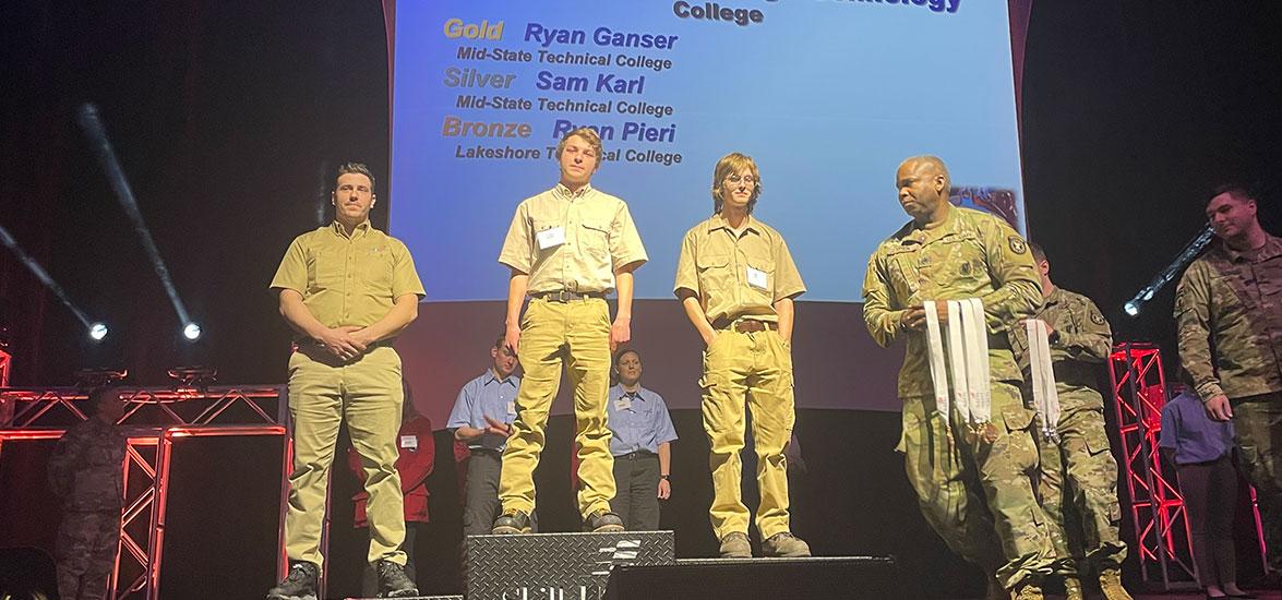 Ryan Ganser, center podium, and Sam Karl, right podium, receive their gold and silver medals in the Precision Machining competition at the 49th annual SkillsUSA State Leadership and Skills Conference in Madison, April 5. The winners were among 12 Mid-State students who medaled in their respective competitions at the event. 