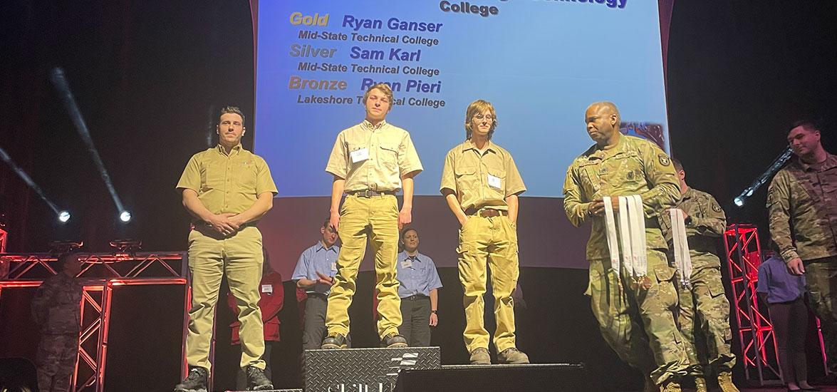 Ryan Ganser, center podium, and Sam Karl, right podium, receive their gold and silver medals in the Precision Machining competition at the 49th annual SkillsUSA State Leadership and Skills Conference in Madison, April 5. The winners were among 12 Mid-State students who medaled in their respective competitions at the event.