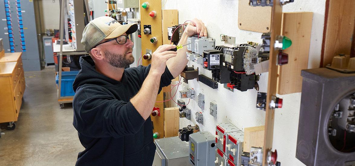 A Mid-State Construction Electrician apprentice practices wiring electric motor control circuits as part of his hands-on training in the program. The apprenticeship is one of 13 offered at Mid-State and eligible for the Tools of the Trade scholarship program each year.
