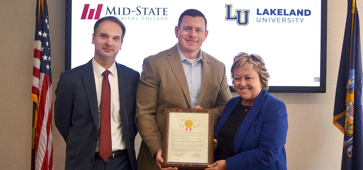 State Sen. Patrick Testin presents Lakeland University and Mid-State Technical College a citation commemorating the 30-year anniversary of the institutions’ partnership on May 17, 2022, on the Wisconsin Rapids Campus of Mid-State Technical College. From left, Dr. Joshua Kutney, Lakeland University vice president for academic affairs; Sen. Patrick Testin; and Dr. Shelly Mondeik, Mid-State president.