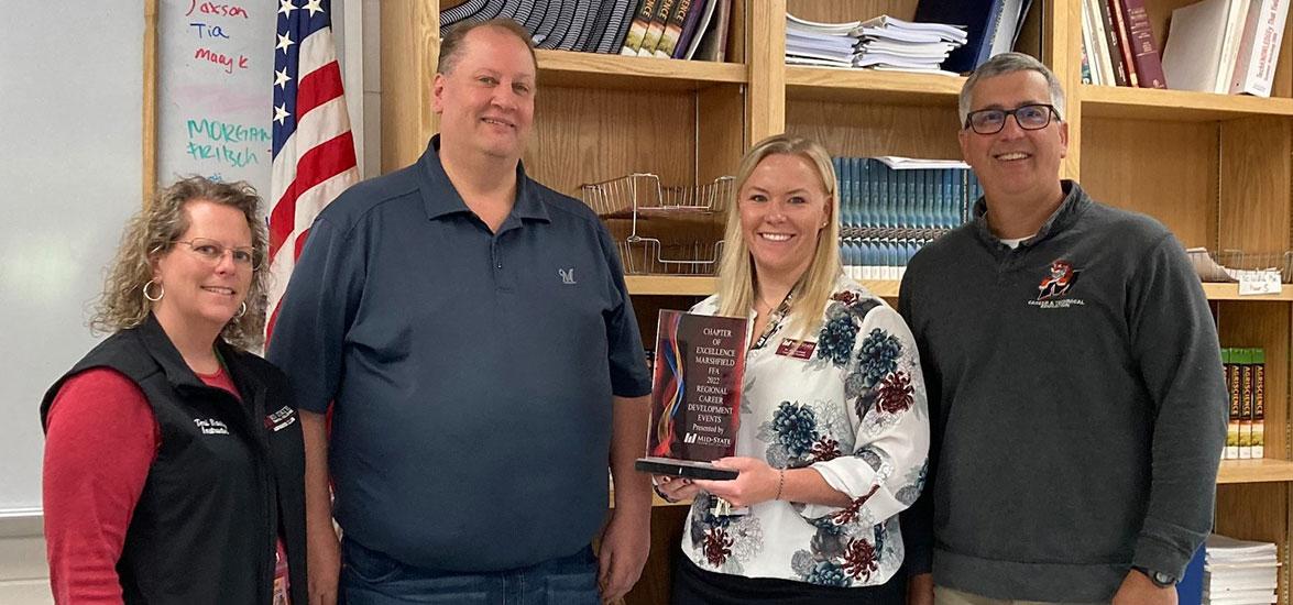 From left, Dr. Alex Lendved, dean of Mid-State’s Marshfield Campus and agriculture programs, and Teri Raatz, Mid-State agribusiness instructor, present Chapter of Excellence award to Mark Zee and Tim Heeg, Marshfield School District FFA advisors.