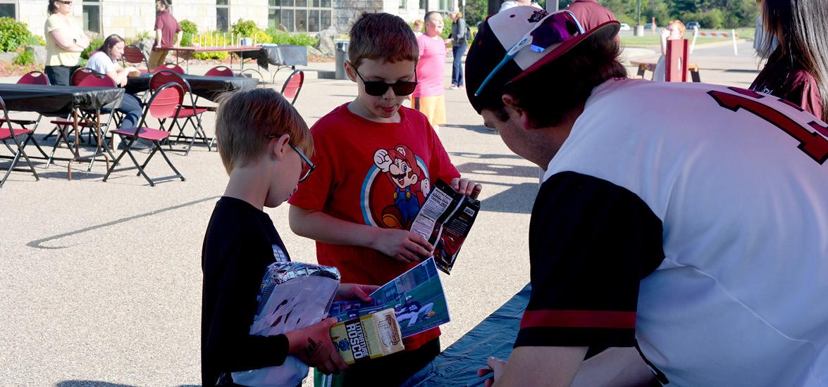 Ben Krause, center, gets an autograph from Wisconsin Rapids Rafters pitcher Grant Manning at the Rafters Meet-and-Greet event on Mid-State’s Wisconsin Rapids Campus, June 7.