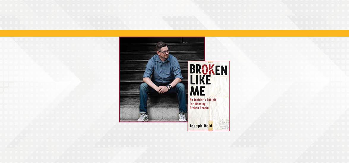 Joseph Reid sitting on steps with an image of the cover his book, "Broken Like Me."