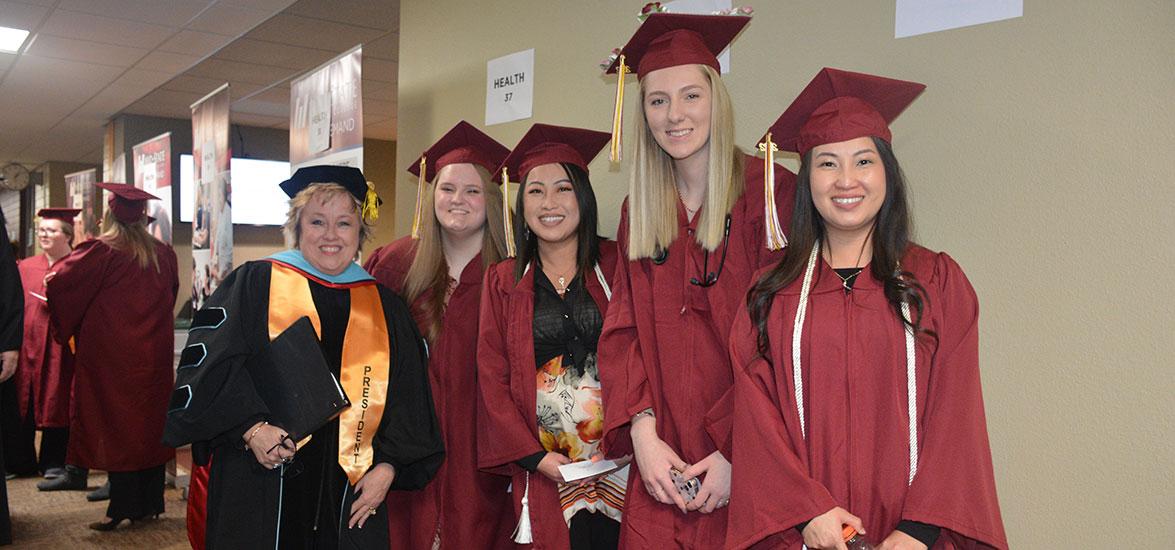 Mid-State’s president, Dr. Shelly Mondeik, with graduates just before the procession at the College’s commencement ceremony on the Wisconsin Rapids Campus, Dec. 10.