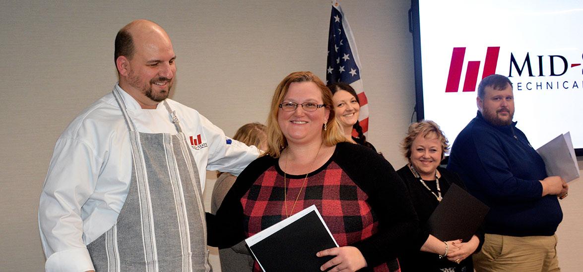 Mid-State Culinary Arts instructor Ryan Petrouske congratulates Culinary Foundations certificate completer Angela Kolb at the recognition ceremony held in the Gourmet Café on the Wisconsin Rapids Campus, Feb. 15. 