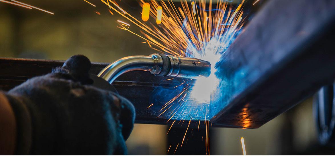 Student welds pieces of metal together.