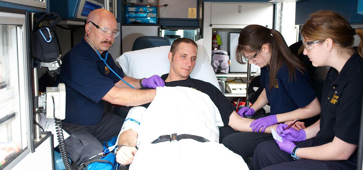 Medical team in an ambulance assess a patient.